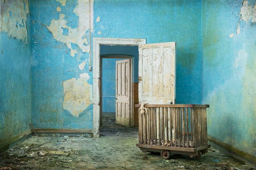 Blue room, vintage toys, doorway and doors, derelict Hellingly Asylum, West Sussex