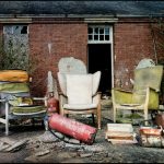 Three battered armchairs outside, derelict Hellingly Asylum, West Sussex