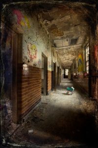 Child's toy pram in corridor, with murals, windows and doorways, derelict Hellingly Asylum, West Sussex