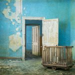 Blue room, vintage toys, doorway and doors, derelict Hellingly Asylum, West Sussex