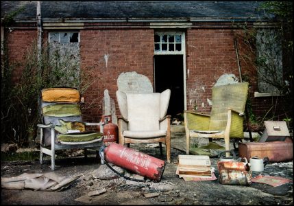 Three battered armchairs outside, derelict Hellingly Asylum, West Sussex
