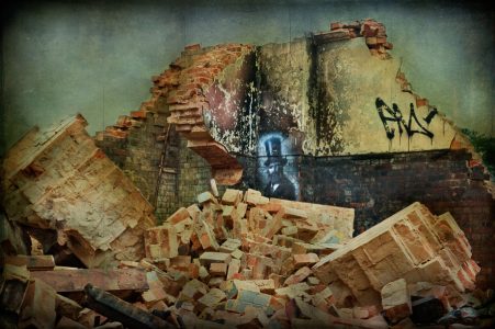 Remains of demolished hall and painting by street artist Req, derelict Hellingly Asylum, West Sussex