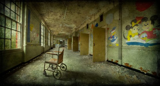 Wheelchair in corridor, with Disney murals, derelict West Park Asylum, Epsom, Surrey