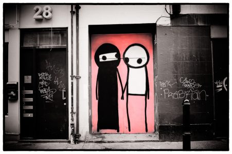 Street art in East London, two figures on a door, by artist Stik